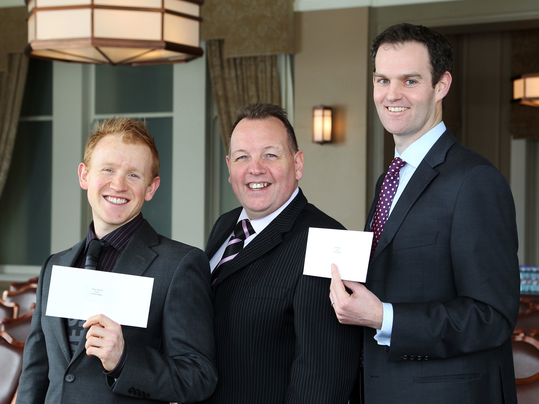 Eddie Reid, TGI Golf managing director (centre) with Scottish Region PGA Assistants of the year Oliver Morton (left) and David Patrick (right).