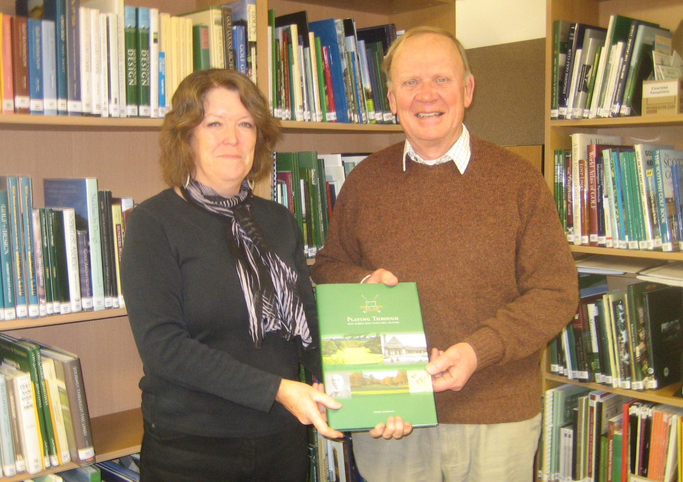 Derek Markham presenting his history of West Surrey Golf Club to Sue Stranger