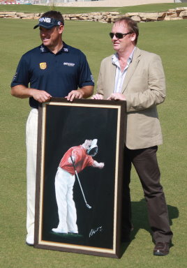 Artist in Residence Mark Robinson presenting a painting to winner Lee Westwood