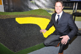 Murray Long with the Blinder product, which demonstrates that it can sprayed to match the sand colour or to highlight the run and position of the drainage system.