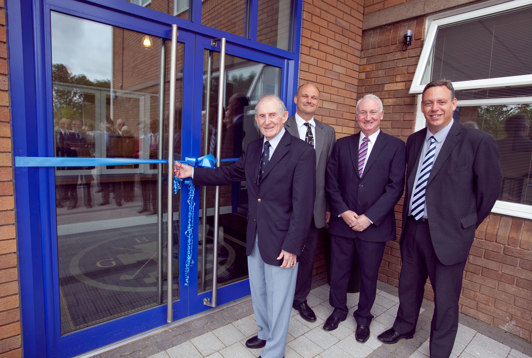 John Martin, a long-standing member of Bromborough Golf Club, prepares to cut the ribbon to officially open the new facilities. Also shown are John Fillingham of NatWest, Terry Keenan, Chairman BGC and a representative of Read Construction.