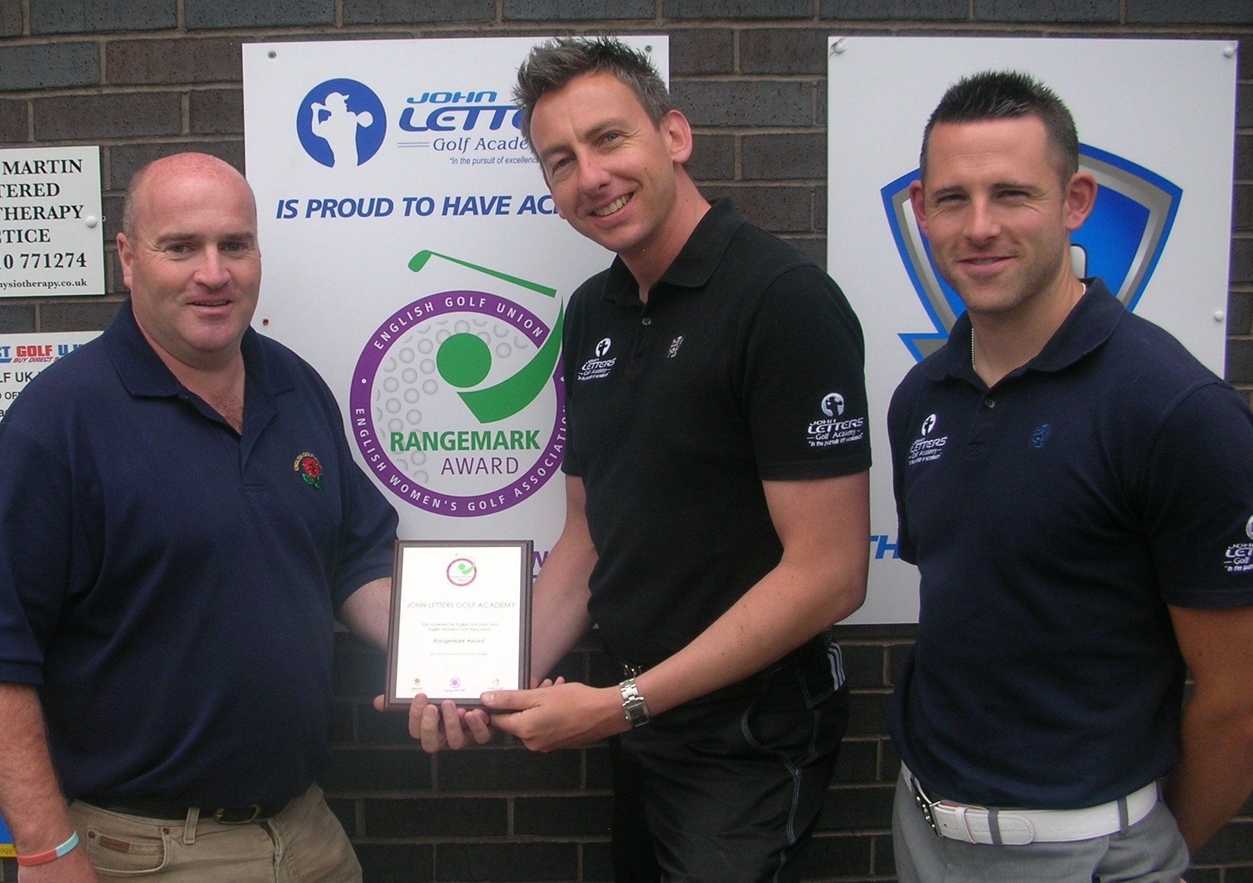 James Beattie, Junior Development Co-ordinator, John Letters Golf Academy is awarded the RangeMark Plaque by Richard Brown of the EGU, watched by John Letters Golf Academy Director Tom Denby