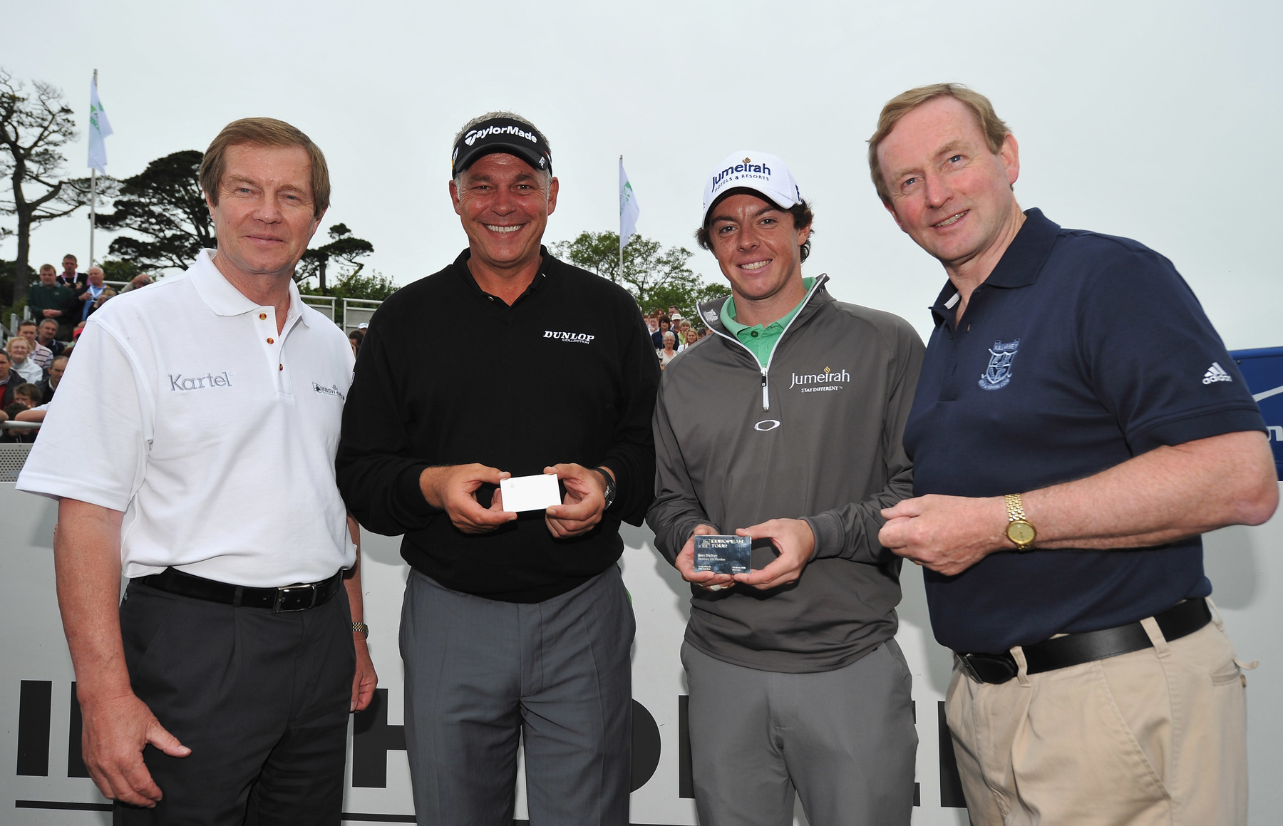 (l-r) George O’Grady, Chief Executive of The European Tour, presents Honorary Life Membership cards to Darren Clarke and Rory McIlroy in the presence of Ireland’s Taoiseach, Enda Kenny (Getty Images).