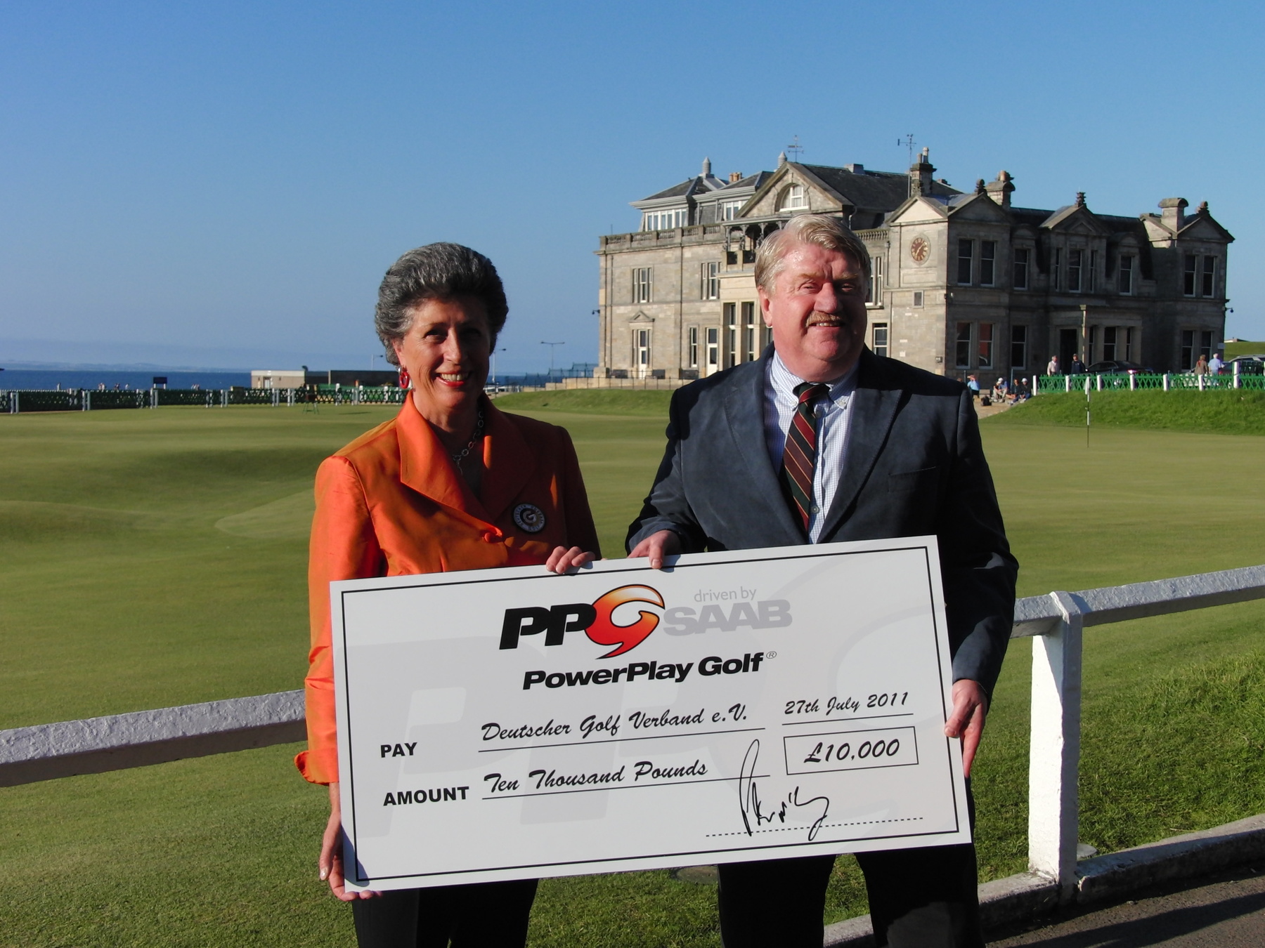 Vice President of the German Golf Federation, Marion Thannhaeuser receives Maximilian Kieffer’s donation of £10,000 courtesy of his PowerPlay Golf driven by Saab: Ignition 7th place finish, from PPG Executive Director Peter McEvoy 