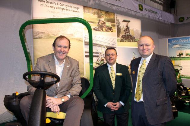(left to right): Jerry Kilby, executive director of the UKGCOA, with John Deere’s national account manager Paul Trowman and turf division sales manager Joedy Ibbotson on the John Deere stand at BTME 2012 in Harrogate .