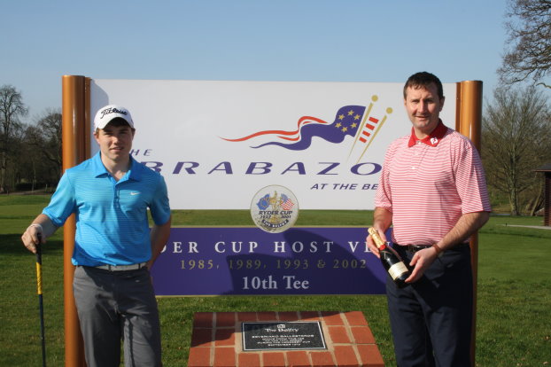 Dan O’ Connor (left) is presented with a commemorative bottle of champagne from The Belfry’s Director of Golf, Gary Silcock, next to the Seve Ballesteros plaque behind The Brabazon 10th tee.
