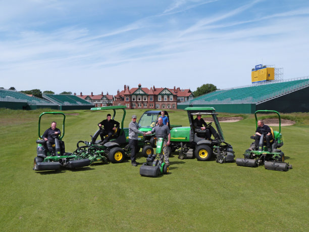 Royal Lytham and St Annes Golf Club head greenkeeper Paul Smith and Balmers dealer salesman Darren Barker (centre left and right) with some of the greenkeeping staff and their existing John Deere machines, prior to delivery of the tournament support equipment for The Open.