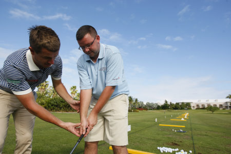PGA professional Matt Hearne from Milford Haven Golf Club coaching amateur Liam Eva (courtesy of Tom Dulat at Getty Images)