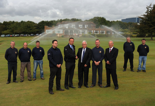 Shaking hands in the centre are Robin Farrer, right, and Lely’s Robert Jackson, with, front row from left, Nathan George from MJ Abbott, Chris Carpenter and club chairman Bryan Peirson. The greenkeeping team look on.
