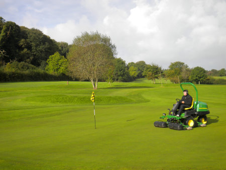 Gareth Knight, golf course estates manager at Trefloyne Golf Club, driving the John Deere 2500E hybrid electric greens mower