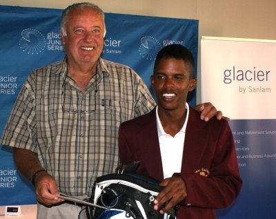 George Schwartzel, father of Charl Schwartzel, presents a prize to junior golfer Keelan van Wyk after his victory in the Charl Schwartzel Tournament in the Glacier Junior Series.