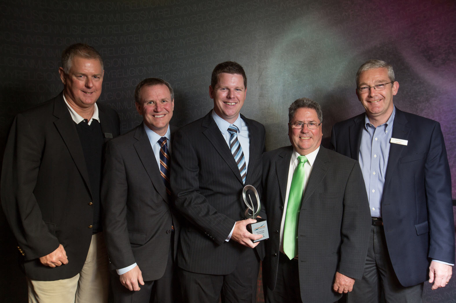 Power Turf New Zealand Ltd are presented with the Service Dealer of the Year award