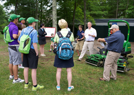 Ren Wilkes, regional sales manager for John Deere Golf, shows students the benefits of John Deere's E-Cut hybrid technology