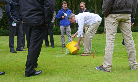 Dr David T Jones ‘charming’ earthworms out of the soil with a solution of mustard powder and water