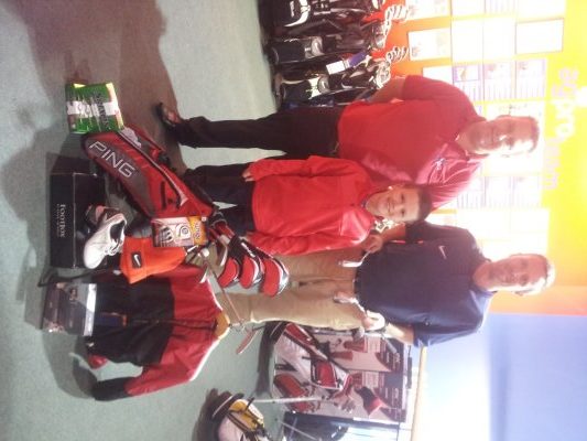Adam and his Dad Colin (blue shirt) are pictured with their prize at the american golf store in Belfast