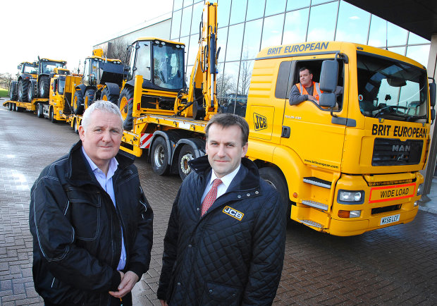 JCB CEO Graeme Macdonald, right, and Andy Walder of the Construction Industry Training Board, see the JCB machines on their way to UK flood disaster zones
