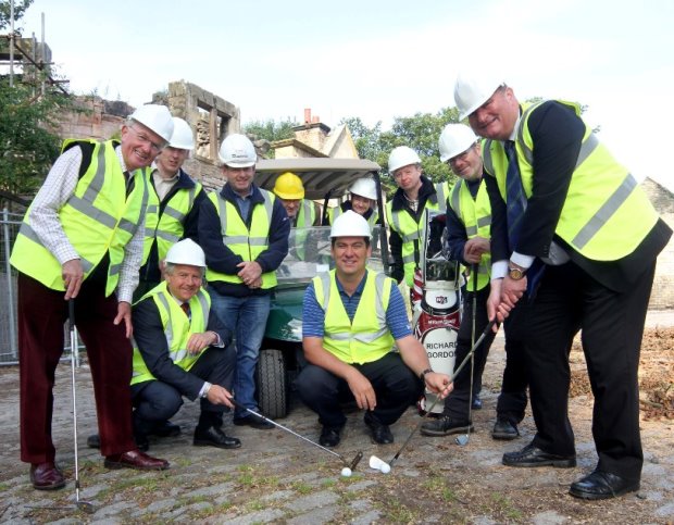 Teeing up for the new clubhouse are Councillor Bill Grant (crouching, second from left), Councillor Allan Dorans (far right), Norman McLean from Friends of Belleisle Park (far left) and Belleisle golf professional Richard Gordon (crouching, in the middle).
Behind Councillor Grant are (left to right) Seamus McNicholl and Craig Beck from contractors T&A Kernoghan. Behind Councillor Dorans are (left to right) golf starter, Kevin Johnston and architect, Stewart Glendinning. Seated in the golf buggy are Council project team officers John McCallum and Val Orrell.