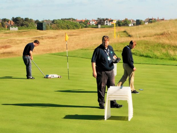 Karl McMullan, Christian Spring, Richard Windows taking measurements on 12th green at Royal Liverpool 