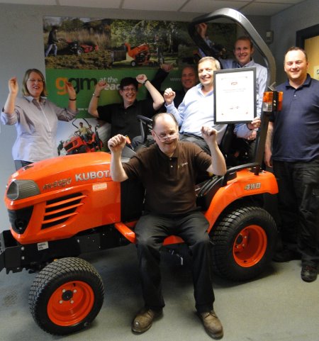 Chris Gibson (sitting) and some of the team celebrate the award