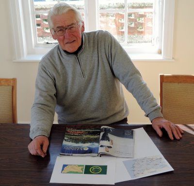 Thorpeness Golf Club Head Professional Frank Hill, photographed in the library with the map of Suffolk and the golf magazine that triggered his discovery