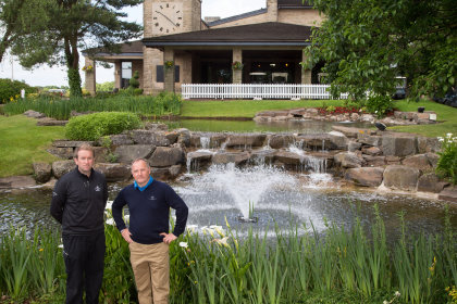 Noel O'Connell, Assistant Head of Irrigation and Special Projects, left, and Jim McKenzie MBE, Director of Golf Courses and Estate Management, with the new Otterbine water feature installed in the pond outside the Celtic Manor lodge golf clubhouse