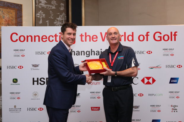 Dr Paul Hawkins presents the trophy to Calum McPherson