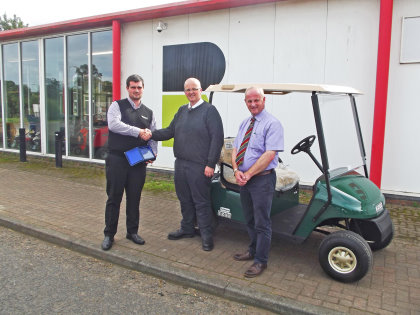 E-Z-GO’s Andrew Bourke (left) presents the UK Dealer Award to David Common and Alistair McRobert
