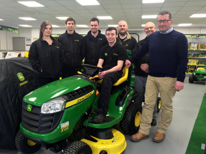 John Deere dealership Balmers GM staff at the new Wakefield premises - (left to right) Louise Swain, Sam Waddington, Mark Balmer, Thomas Balmer (on tractor), Wilf Sykes, Mick Culpan and Chris Johnson