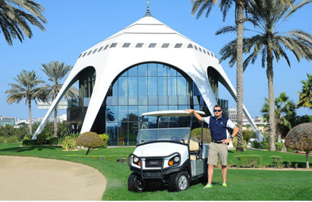 Craig Haldane, Director of Golf Course Maintenance at Dubai Golf, with one of the fleet of Club Car Carryall® vehicles 