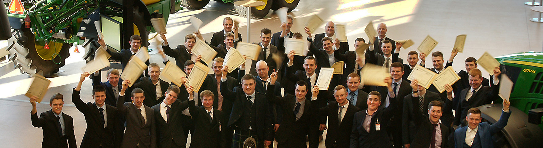 John Deere’s 2016 Ag Tech, Parts Tech and Turf Tech graduates at the John Deere Forum in Mannheim, Germany, with (back row, left to right) John Deere Limited training centre manager Richard Halsall, Deere & Company’s Region 2 training delivery manager Dr Lutz Schueppenhauer, ProVQ’s ‎director of training operations Stuart Jones and managing director Julian Lloyd