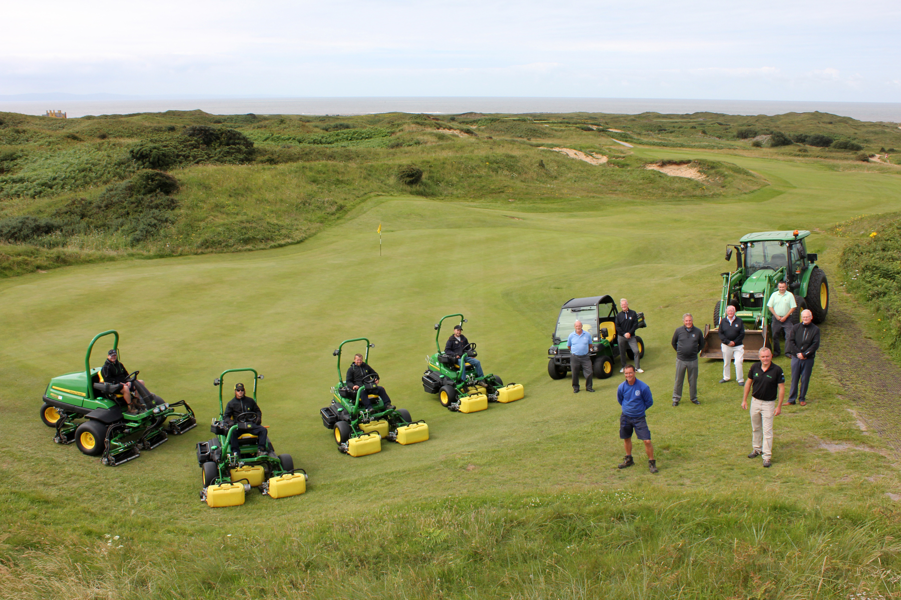 Looking down the 14th hole to the Bristol Channel, (standing front left & right) Pyle & Kenfig Golf Club head greenkeeper Paul Johnson and John Deere dealer Sean Brown of Powercut, with (left to right) committee member Geoff Vincent,chairman of course committee Ian Booth, committee member Wynne Evans, club captain Colin Wood and club secretary/manager Simon Hopkin, with John Deere territory manager Nick Ashman at the rear and members of the greenkeeping team including (left to right) Nathan Jones, Stephen Lambert, Simon Lacey and first assistant Lloyd Preece