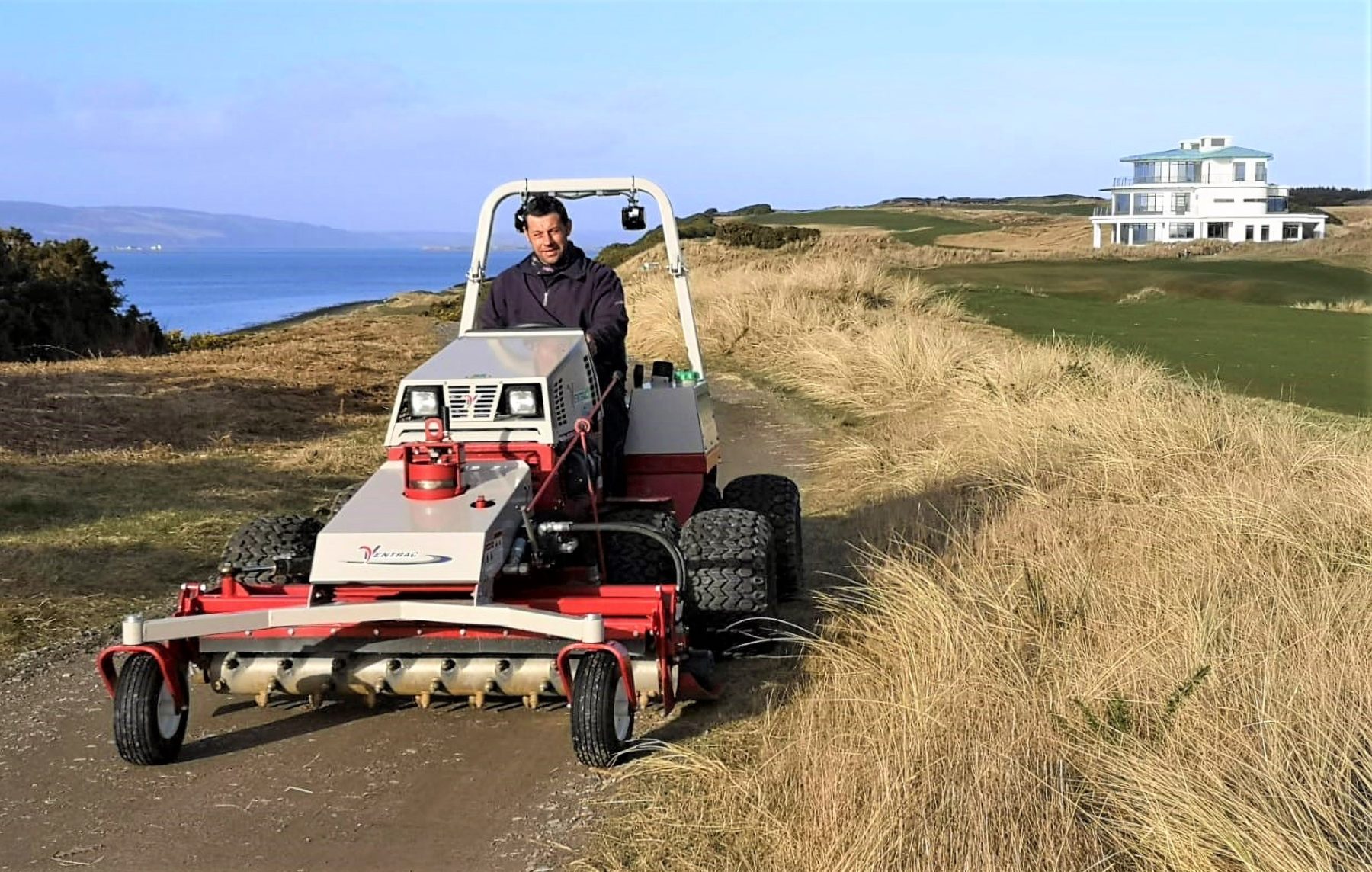 Head greenkeeper James Hutchison with the Ventrac and Power Rake combination at Castle Stuart