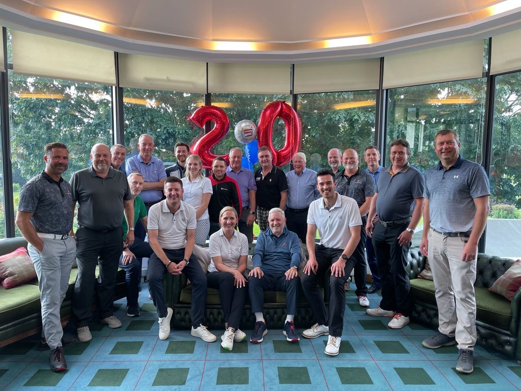 The Sports Impact team, seated, with some its clients