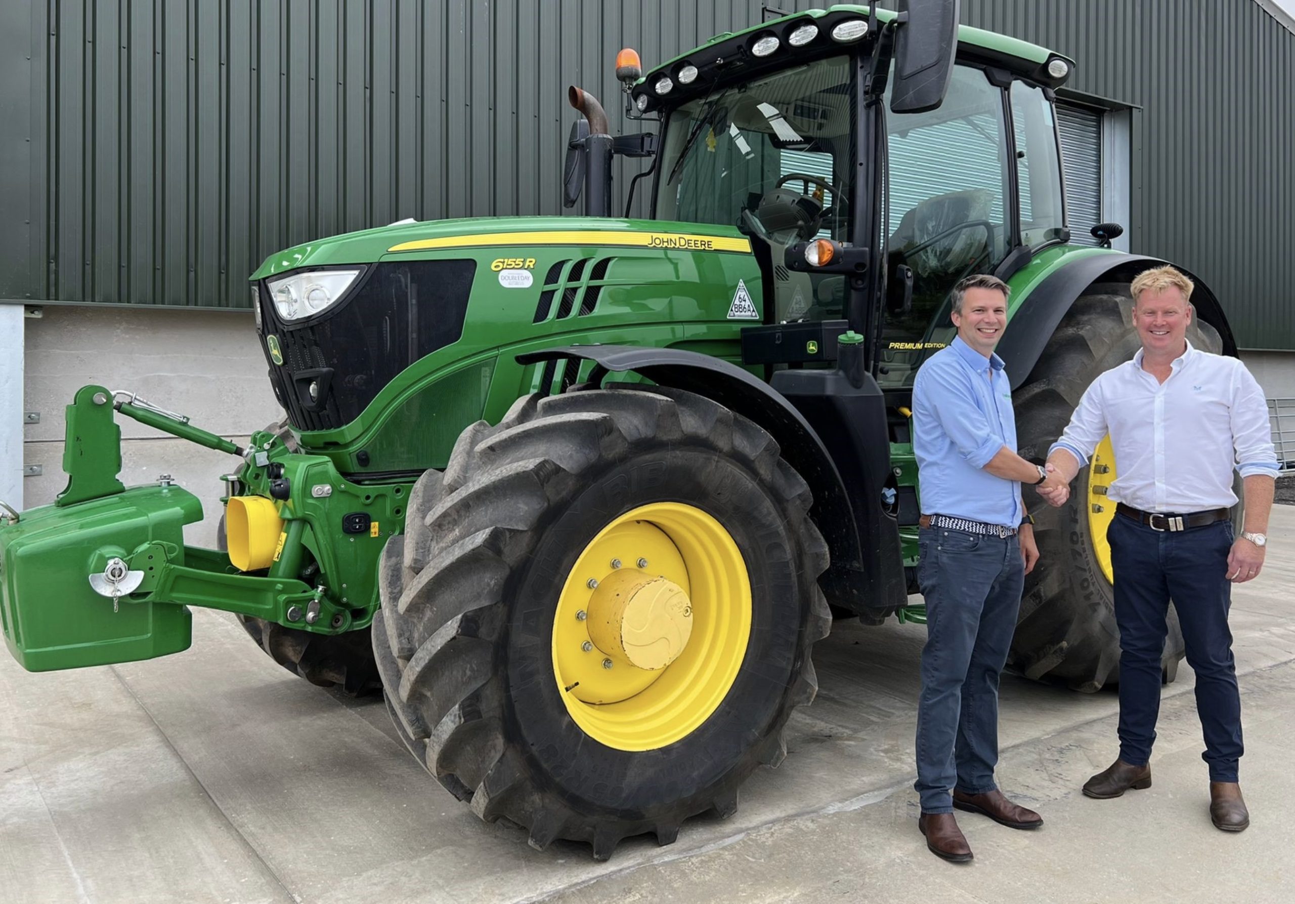 Ben Turner (left) with Ian Doubleday-Collishaw in front of a John Deere 6R 155 tractor