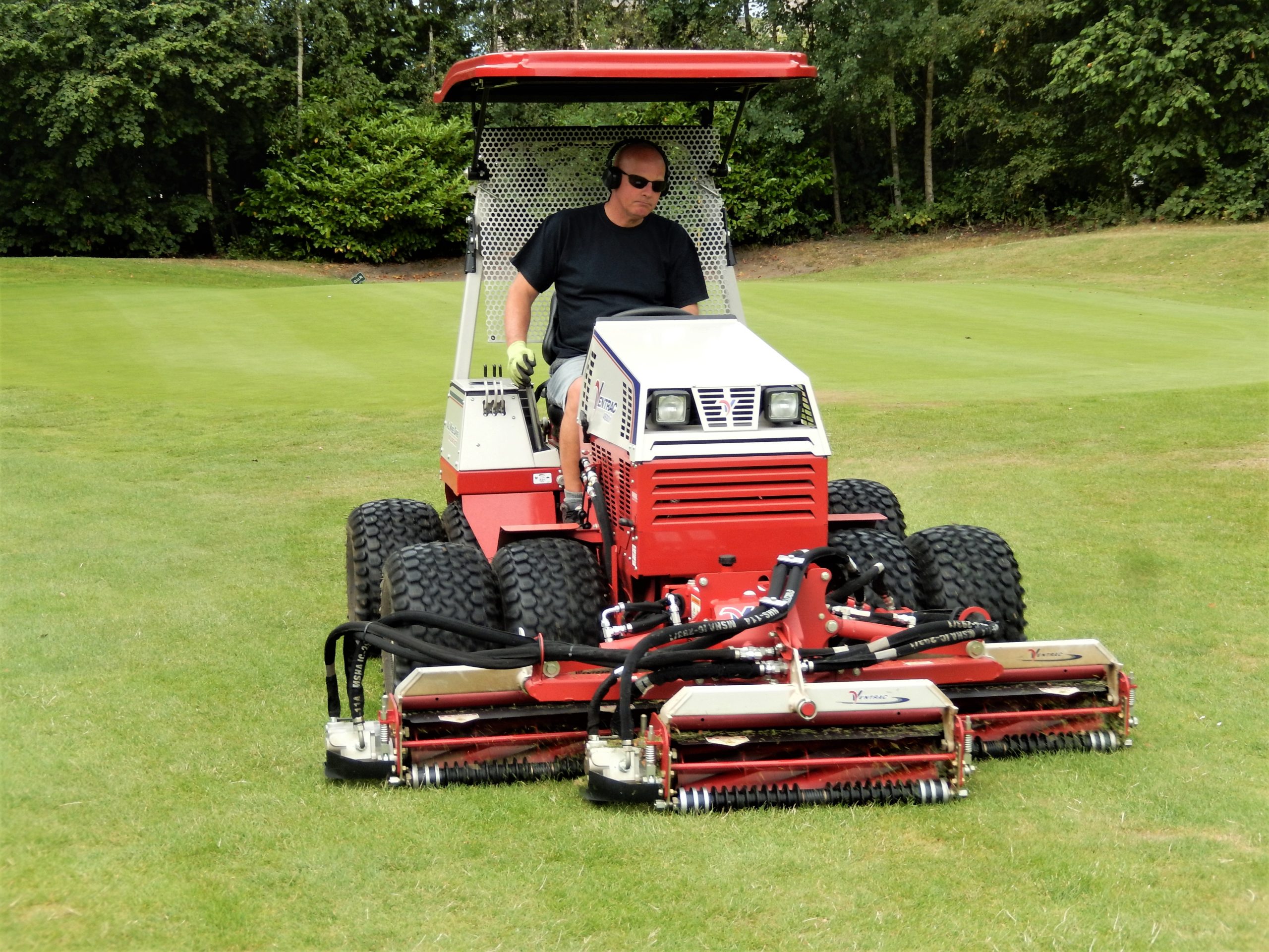 Greenkeper Ian Millington using the Triple Reel mowing attachment