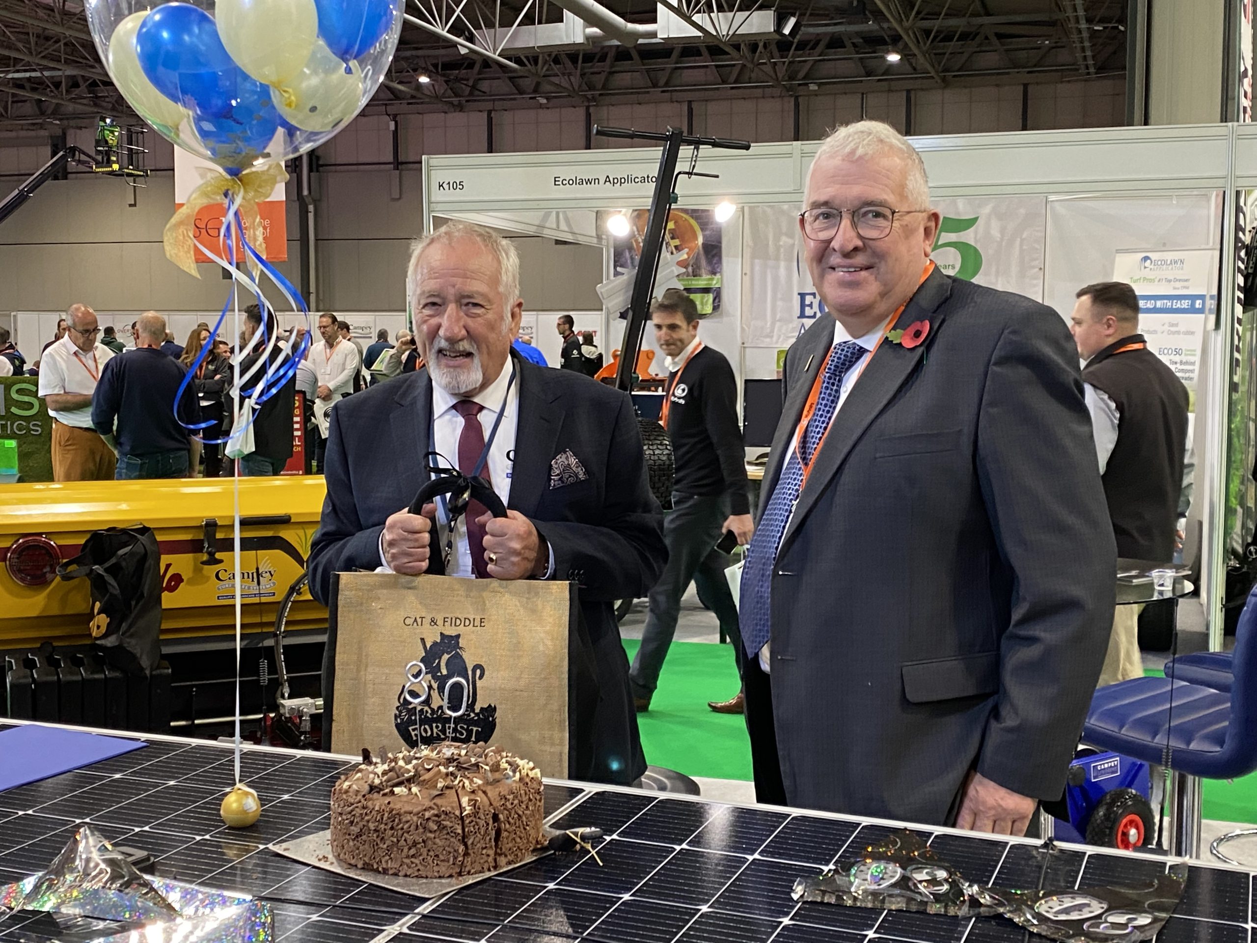 Richard Campey presents Ian Pogson with an 80th birthday present at Saltex