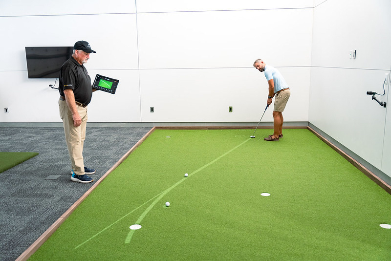 Tim Cutshall and Jody Addison make use of the indoor putting studio in the new Performance Centre at Apes Hill Barbados