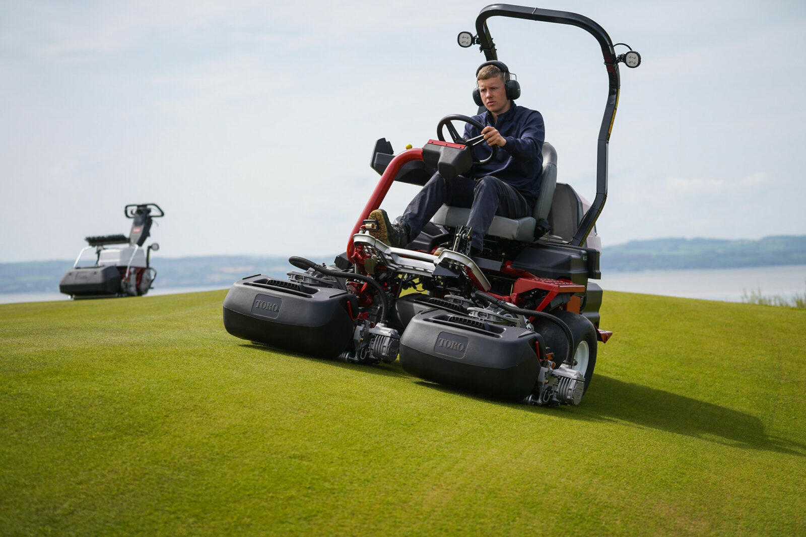 Toro’s Greensmaster eTriFlex 3370 all-electric ride-on greensmower is helping prepare Royal Liverpool for The Open 2023, seen here with assistant greenkeeper, Luke Charnley, who was runner up of the Toro Student Greenkeeper of the Year Young Award 2022