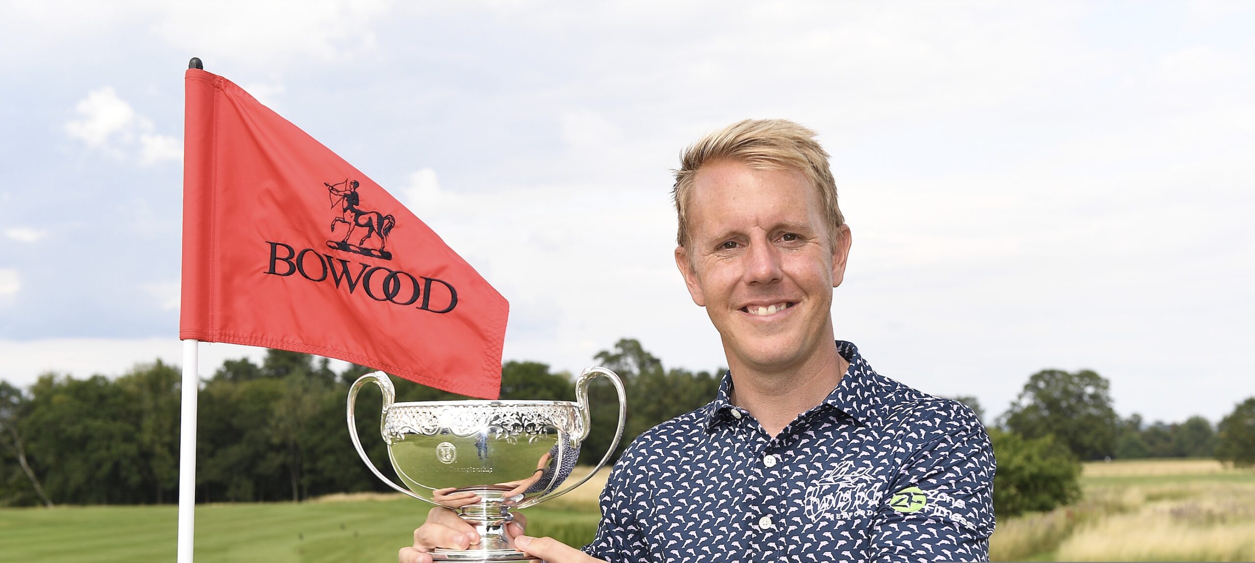 James Ruth lifts the English PGA Championship trophy for the second year running