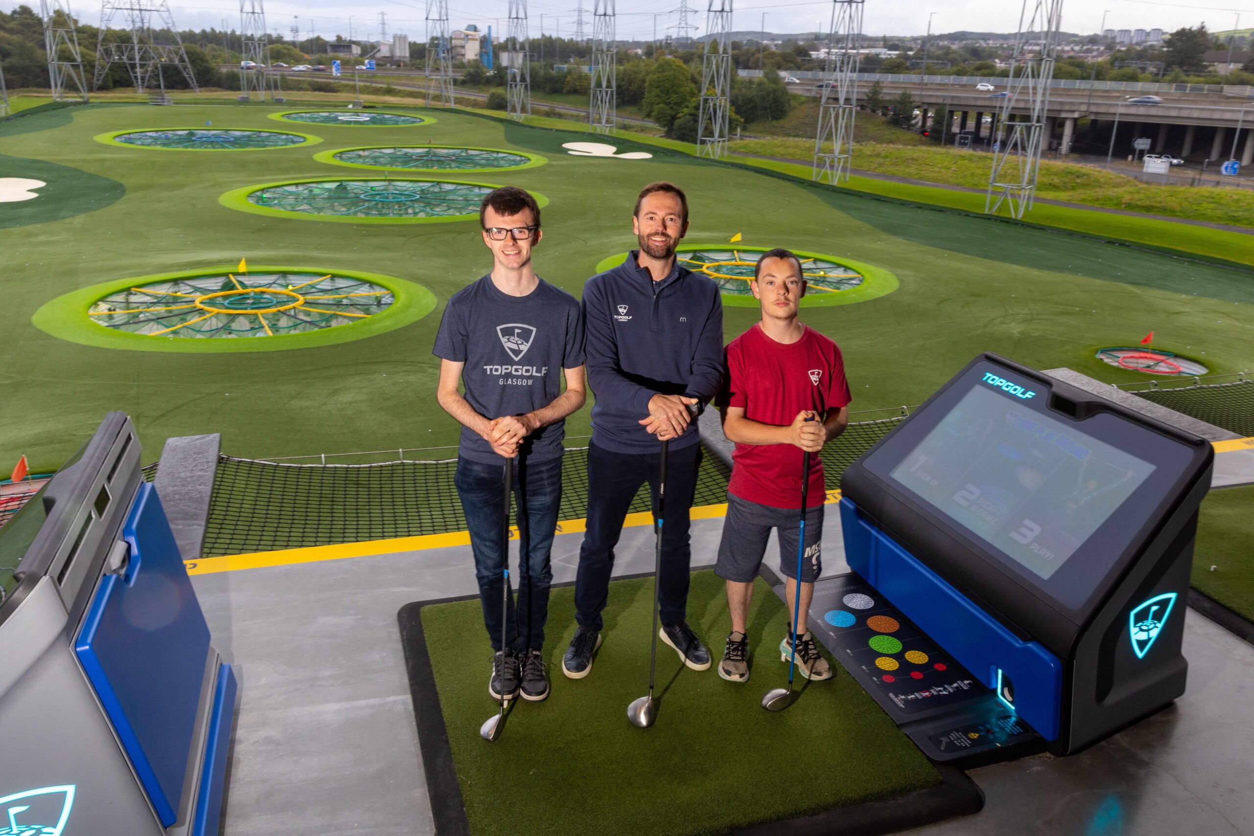 Special Olympics Great Britain athletes Ruairidh Brown (left) and Darren Carruthers (right) with Kenneth Mclean, Director of Instruction at Topgolf Glasgow