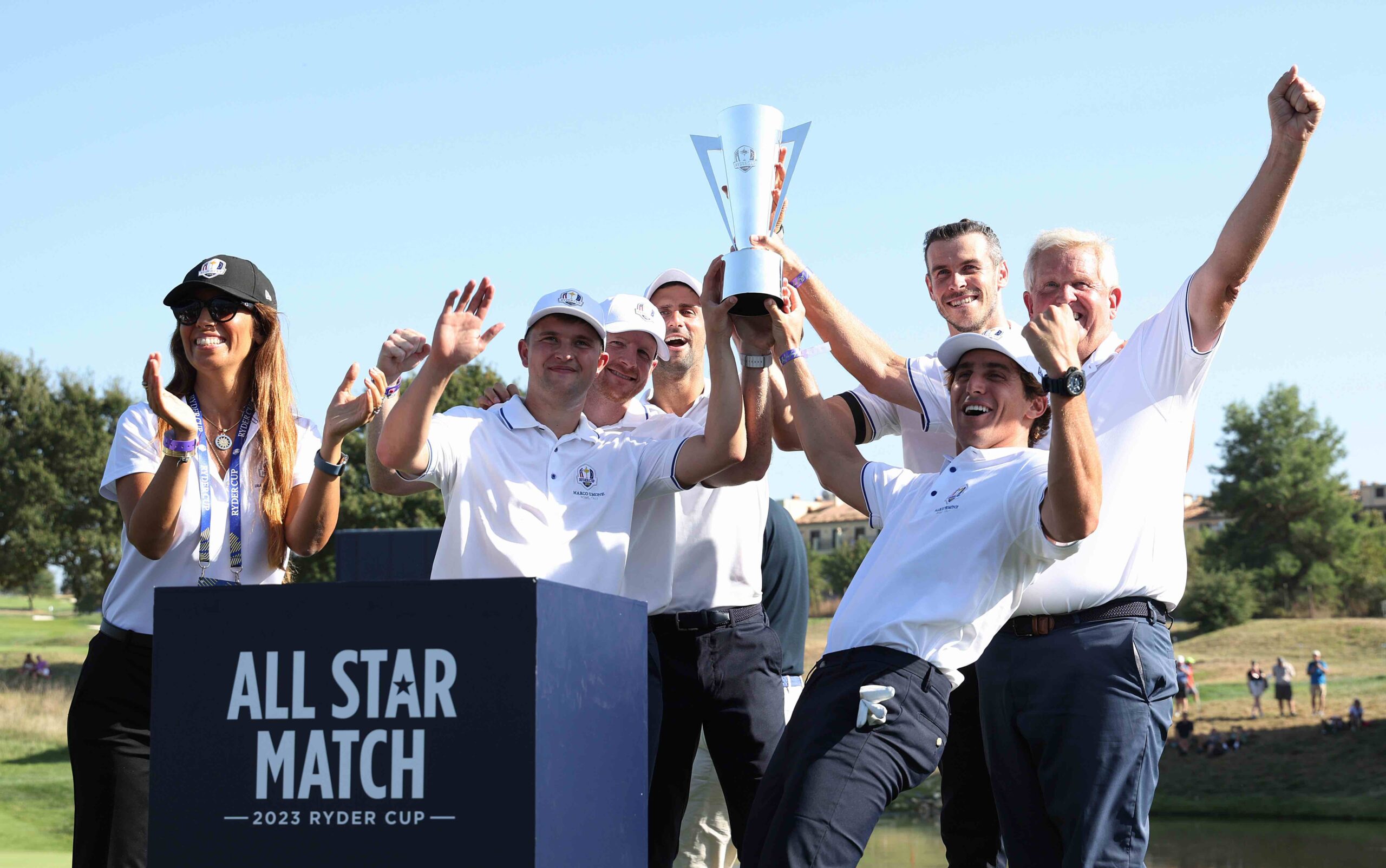 Kipp Poppert, Garrett Hilbert, Novak Djokovic, Gareth Bale, Leonardo Fioravanti, and Colin Montgomerie celebrate with the trophy following victory during the All-Star Match at Marco Simone