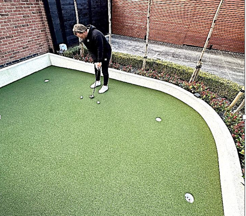 Tom Lewis practicing at home on his recently installed Huxley Golf green 