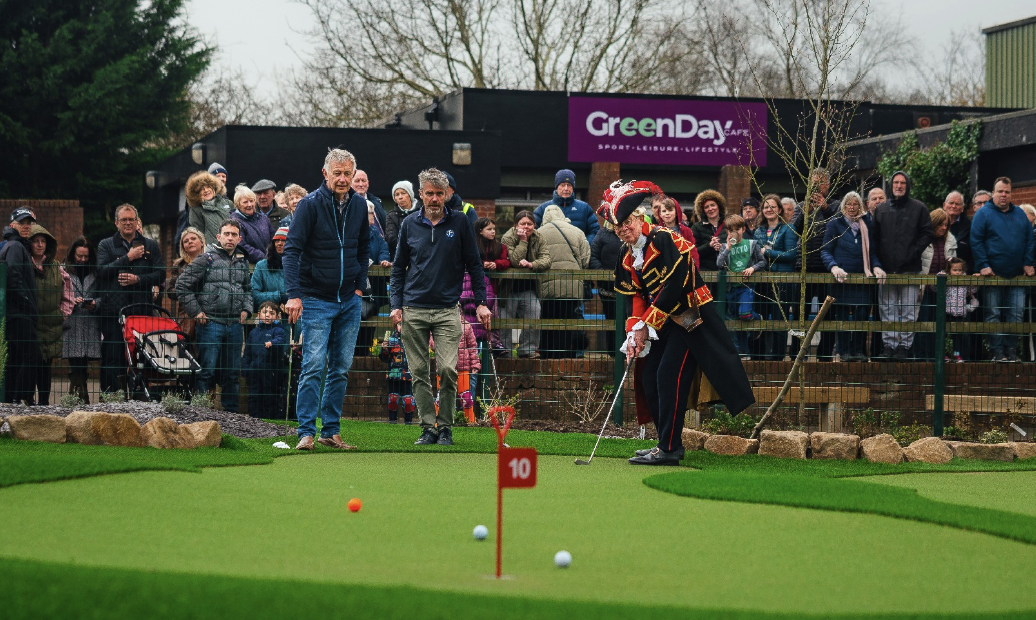 Ken Brown, course designer Ken Moodie, and Chester's Town Crier play the opening match at the new GreenDay Putting Course in Chester