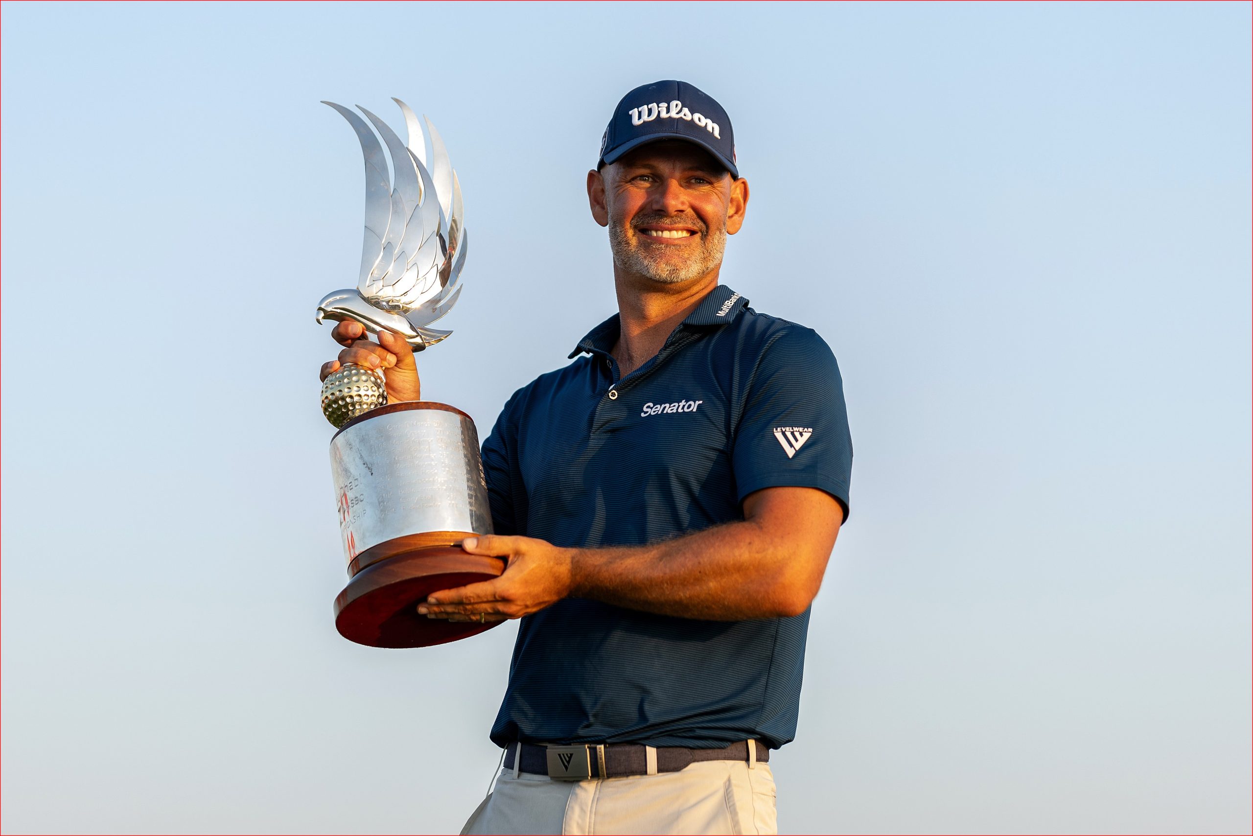 Wilson staff player Paul Waring lifts the Abu Dhabi HSBC Championship