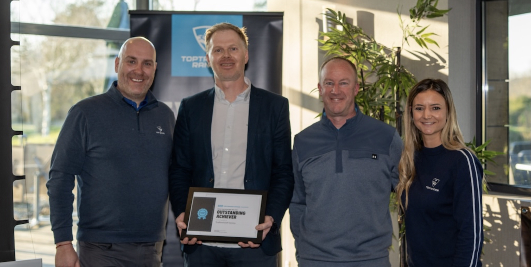 Trafford Golf Centre's Director of Golf Pete Styles and Operations Manager Michael Clarke (centre) receiving the award from Toptracer representatives