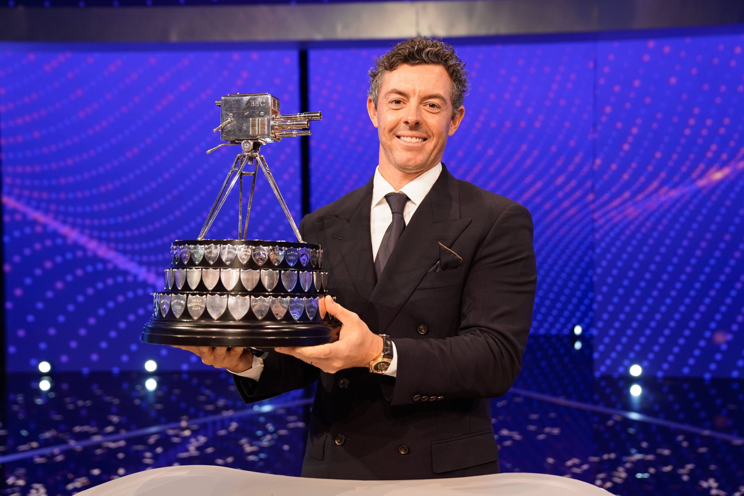 Rory McIlroy lifts the 2025 BBC Sports Personality of the Year trophy (Credit: BBC/James Stack