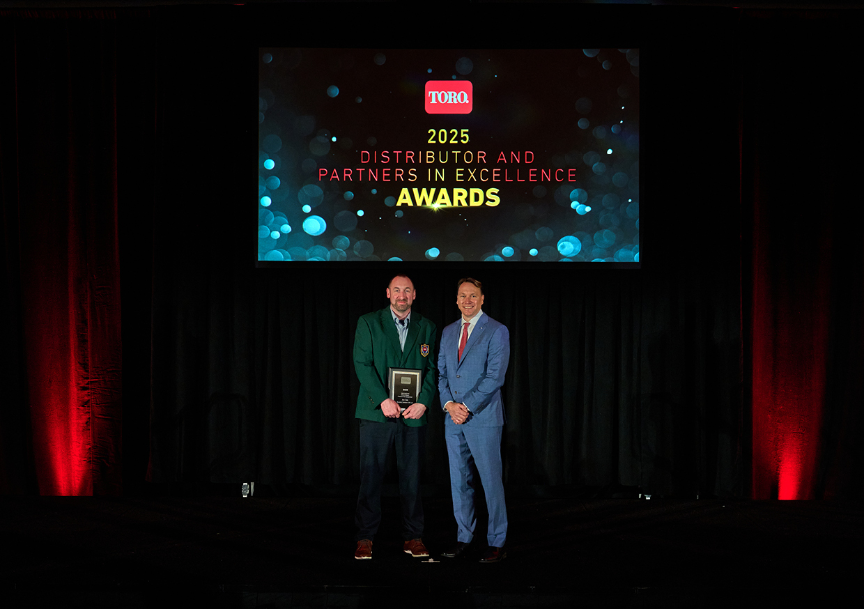 Jon Cole, Divisional Business Manager for Reesink Turfcare, left, receives the Toro Green Blazer Award from Greg Laurence, General Manager of the International Division of The Toro Company.