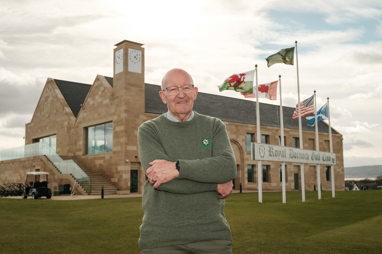 2026 Scottish Golf Lifetime Achievement Award winner Willie Mackay poses for a photo outside the new Royal Dornoch clubhouse (Photo Chris Young/Scottish Golf)