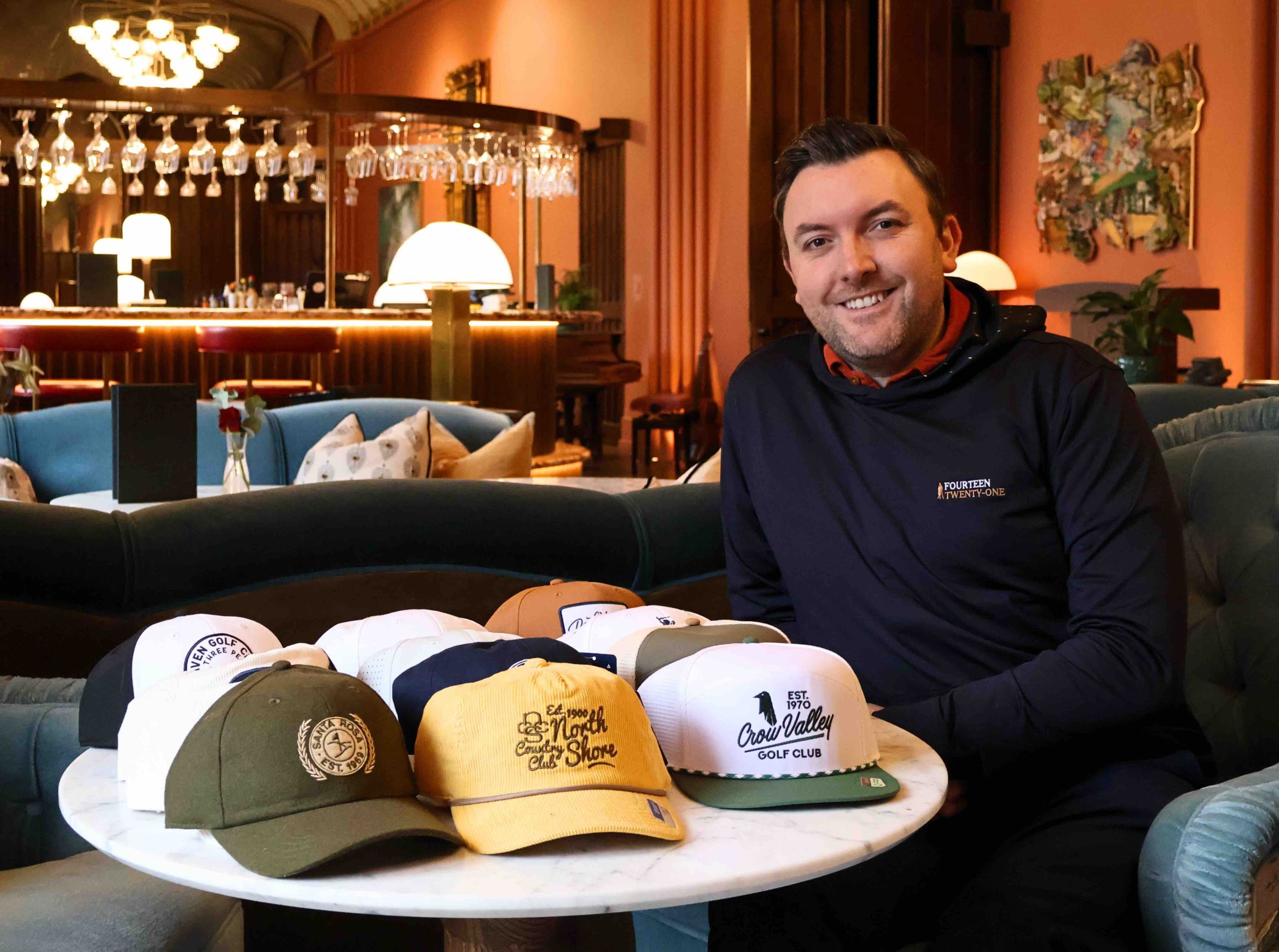 Paul Robinson, founder of Fourteen Twenty-One, with a selection of Ahead's custom designed headwear